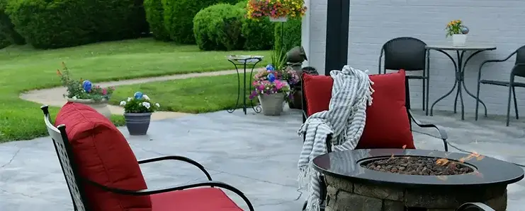 Outdoor patio with fire pit, seating area, and landscaped yard