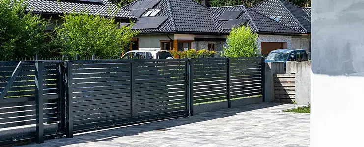 Paver driveway leading to a wooden garage door